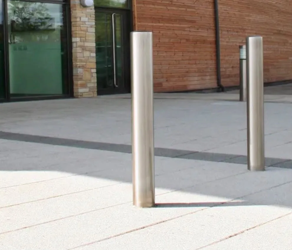 Flat top stainless steel bollards outside a building entrance