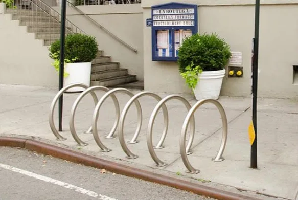 Stainless steel spiral cycle rack on a pavement